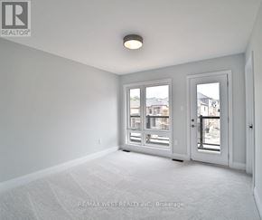 Springwater (Minesing) apartment for rent - A room with a carpet floor and a window with a view of buildings outside.