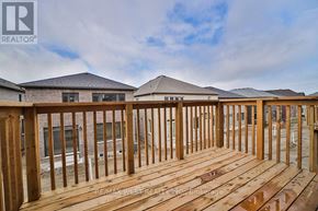 Springwater (Minesing) apartment for rent - A wooden deck with a railing is in the foreground of a construction site with houses in the background.