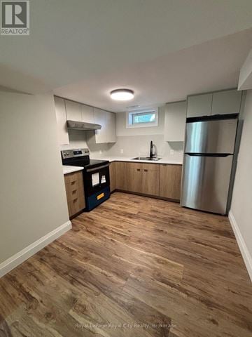 Guelph (Riverside Park) apartment for rent - A kitchen with wooden floors and stainless steel appliances.