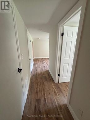 Guelph (Riverside Park) apartment for rent - A hallway with white walls and wood flooring.