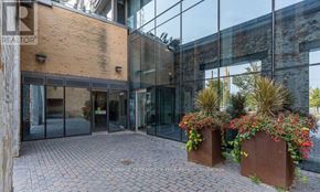 Toronto (Waterfront Communities) condo for rent - A building entrance with glass walls and a brick floor.