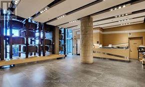 Toronto (Waterfront Communities) condo for rent - A spacious room with a reception desk and a large pillar.