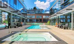 Toronto (Waterfront Communities) condo for rent - A large indoor swimming pool with a glass wall surrounding it.