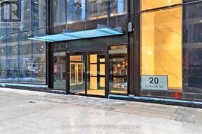 Toronto (Bay Street Corridor) condo for rent - The entrance to a building with a glass facade and a sign that reads "20 EDWARD ST."