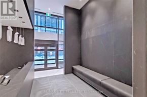 Toronto (Bay Street Corridor) condo for rent - A hallway with a bench and a window in the background.