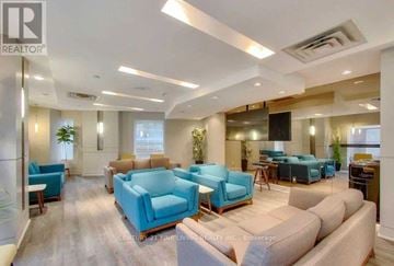 Toronto (Church-Yonge Corridor) condo for rent - A living room with blue chairs and a wooden floor.