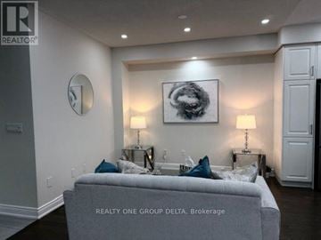 Brampton (Bram West) apartment for rent - A living room with a grey couch and a painting on the wall.