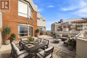 Mississauga (City Centre) condo for rent - A patio with a table and chairs is surrounded by potted plants.