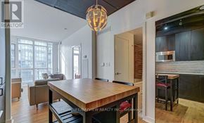 Toronto (Waterfront Communities) condo for rent - A modern kitchen with a wooden table and chairs.