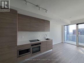 Toronto (Church-Yonge Corridor) condo for rent - A modern kitchen with wooden cabinets and stainless steel appliances.