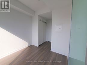 Toronto (Church-Yonge Corridor) condo for rent - A room with wooden flooring and white walls, with a doorway leading to another room.
