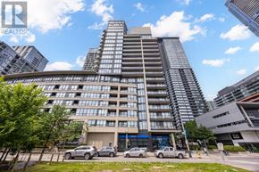 Toronto (Waterfront Communities) condo for rent - A tall residential building with a parking lot in front.