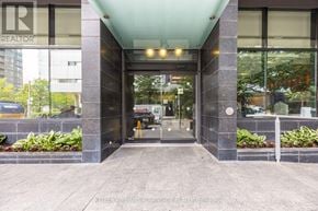 Toronto (Waterfront Communities) condo for rent - The entrance to a building with a glass door and a sign that reads REALTOR.
