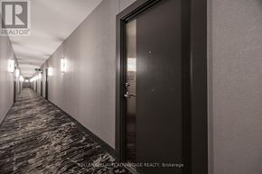 Toronto (Waterfront Communities) condo for rent - A hallway with a door on the right and lights on the left.