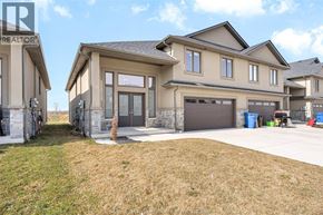 Essex townhouse for rent - A realtor photo of a house with a garage and a driveway.
