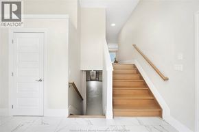 Essex townhouse for rent - A staircase with a wooden handrail and a metal handrail.