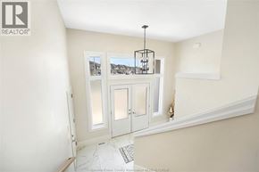 Essex townhouse for rent - A room with a white door and a chandelier hanging from the ceiling.