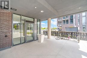 Brampton (Northwest Brampton) condo for rent - A building entrance with glass doors and a bicycle parked outside.