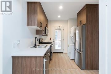 Hamilton (Stinson) multi-family for rent - A modern kitchen with wooden cabinets and stainless steel appliances.