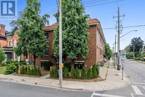 Hamilton (Stinson) multi-family for rent - A street view with a building and a sign that says RE/MAX Escarpment REALTY INC. Brokerage.