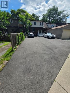 Hamilton apartment for rent - A residential street with cars parked on the side.