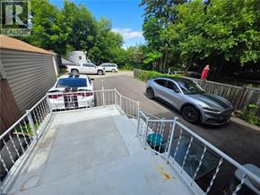 Hamilton apartment for rent - A silver car is parked on a driveway with a white railing.