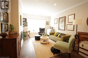 Stratford condo for rent - A living room with a couch, chair, and potted plants.