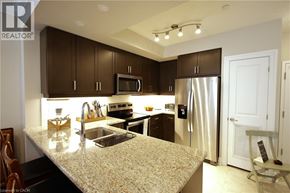Stratford condo for rent - A kitchen with brown cabinets and a granite countertop.