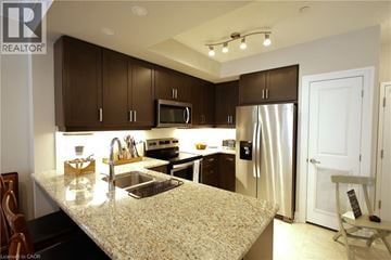Stratford condo for rent - A kitchen with brown cabinets and a granite countertop.