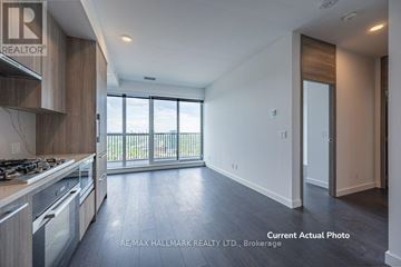 Toronto (Bayview Village) condo for rent - A modern kitchen with a stove top oven and a large window.