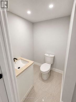 Pickering (Brock Ridge) apartment for rent - A white toilet sits next to a sink in a small bathroom.