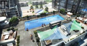 Toronto (Woburn) condo for rent - A swimming pool surrounded by a glass wall with people enjoying the water.