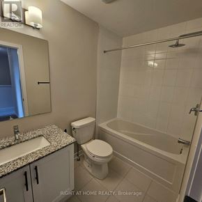 Ottawa townhouse for rent - A bathroom with a toilet, sink, and bathtub.