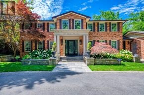 Oakville (Mo Morrison) apartment for rent - A large brick house with a front yard and a driveway.