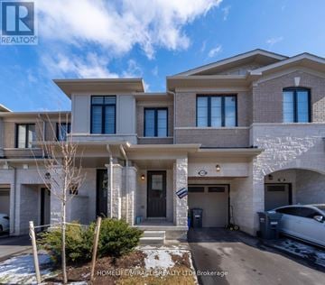 Burlington (Tyandaga) townhouse for rent - A modern two-story house with a garage and a car parked in front.