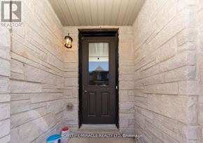Burlington (Tyandaga) townhouse for rent - A brown door is in a stone wall.