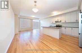 Burlington (Tyandaga) townhouse for rent - A well-lit kitchen with wooden floors and white walls.