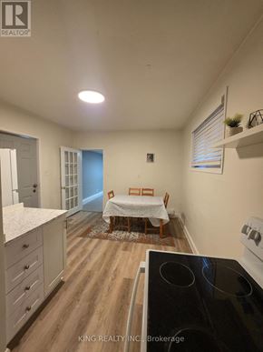 London East (East K) apartment for rent - A kitchen with a dining table and chairs in the middle of the room.