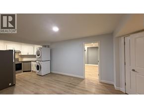 Port Moody apartment for rent - A room with a refrigerator, a washing machine, and a dryer.