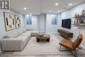 Vaughan (Kleinburg) apartment for rent - A living room with a grey sofa, a brown leather chair, and a wooden coffee table.