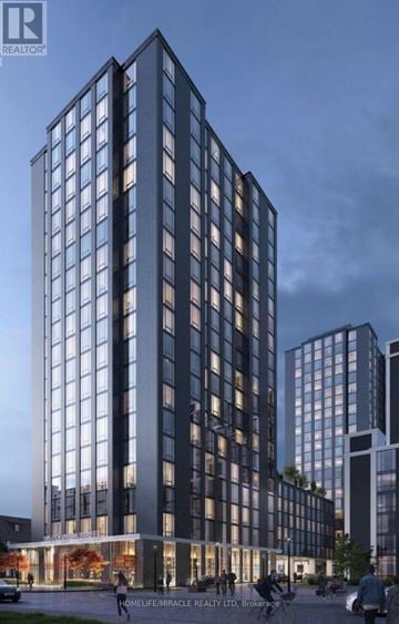 Waterloo condo for rent - A modern building with a glass facade is depicted in the image.