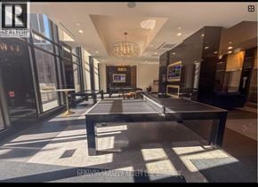 Waterloo condo for rent - A large conference room with a long table and a chandelier.