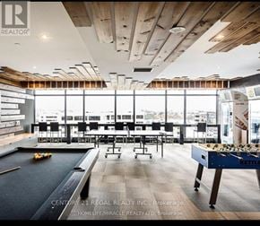 Waterloo condo for rent - A billiards table is in the middle of a room with a pool table on the left.