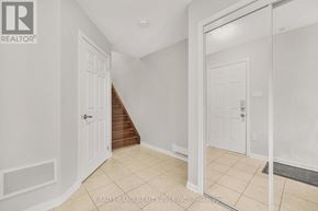 Milton (Wi Willmott) townhouse for rent - A white hallway with a mirror on the wall.