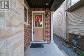 Brampton (Northwest Brampton) apartment for rent - A door with a glass window and a flower decoration on it.
