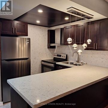 Toronto (Yorkdale-Glen Park) condo for rent - A kitchen with a marble counter top and stainless steel appliances.