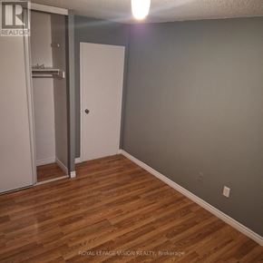 Toronto (Yorkdale-Glen Park) condo for rent - A room with a white door and wooden flooring.