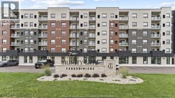 Windsor condo for rent - A large apartment complex with a sign that says Prentice Condominiums.