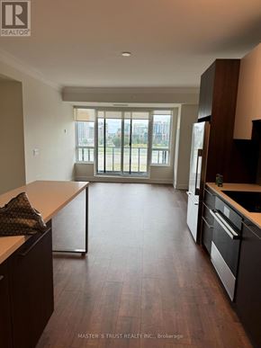 Markham (Unionville) condo for rent - A kitchen with dark wood floors and a large window.