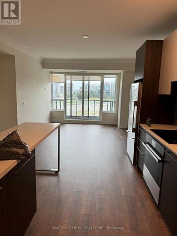 Markham (Unionville) condo for rent - A kitchen with dark wood floors and a large window.